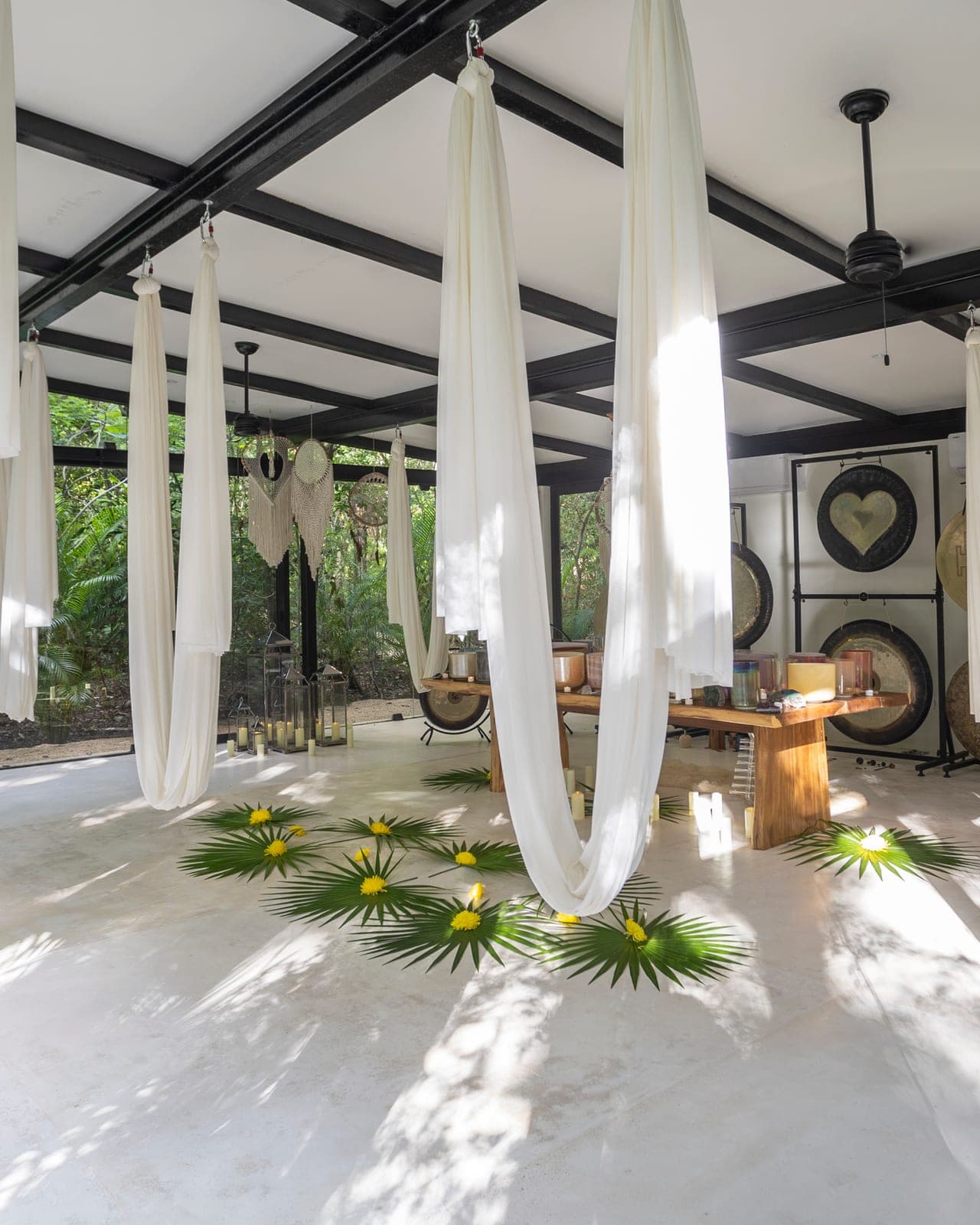 White silk hammocks draped from the black beams of the Sound Temple, planetary gongs and a marigold mandala on the floor