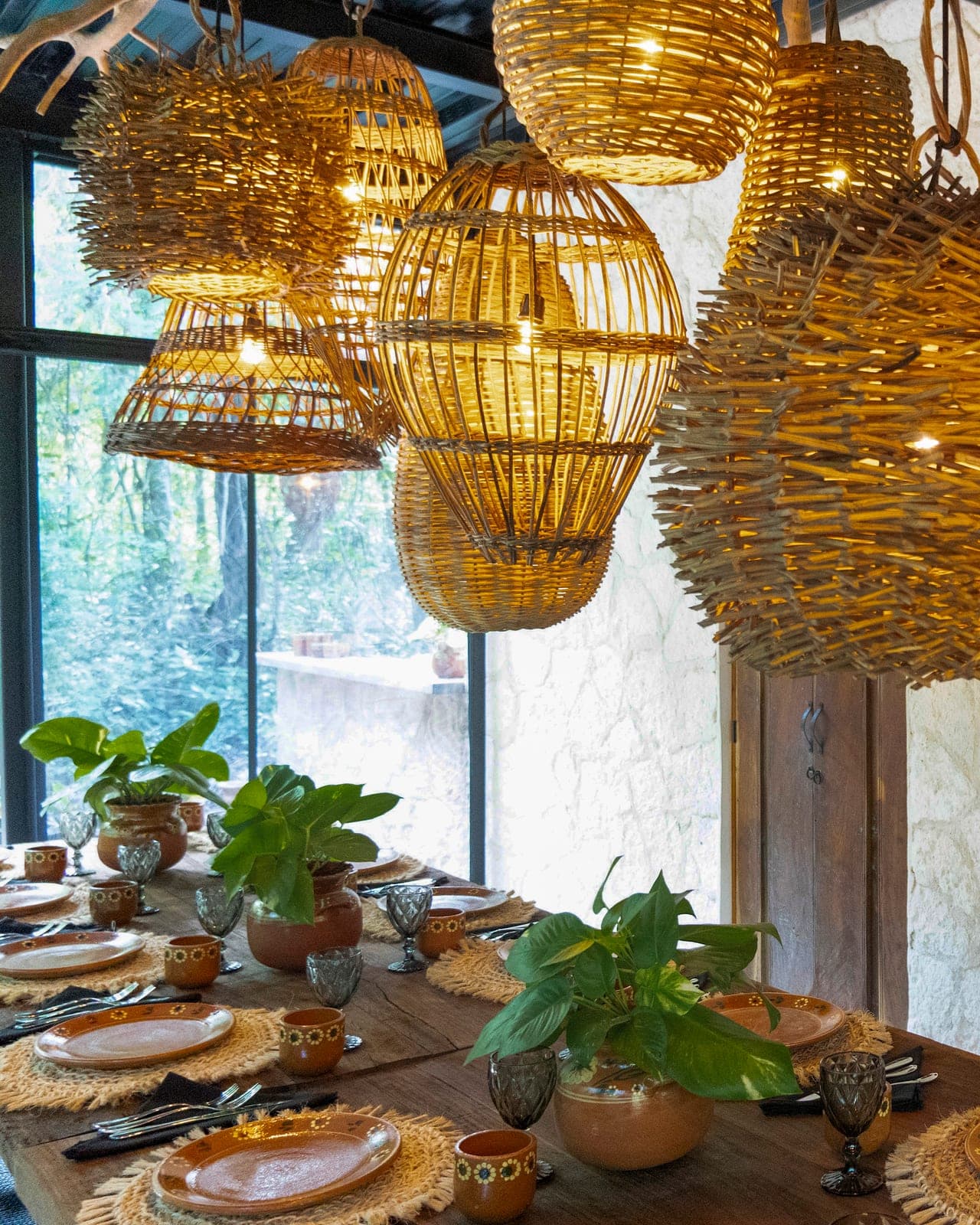 A constellation of glowing wicker lanterns above the set table