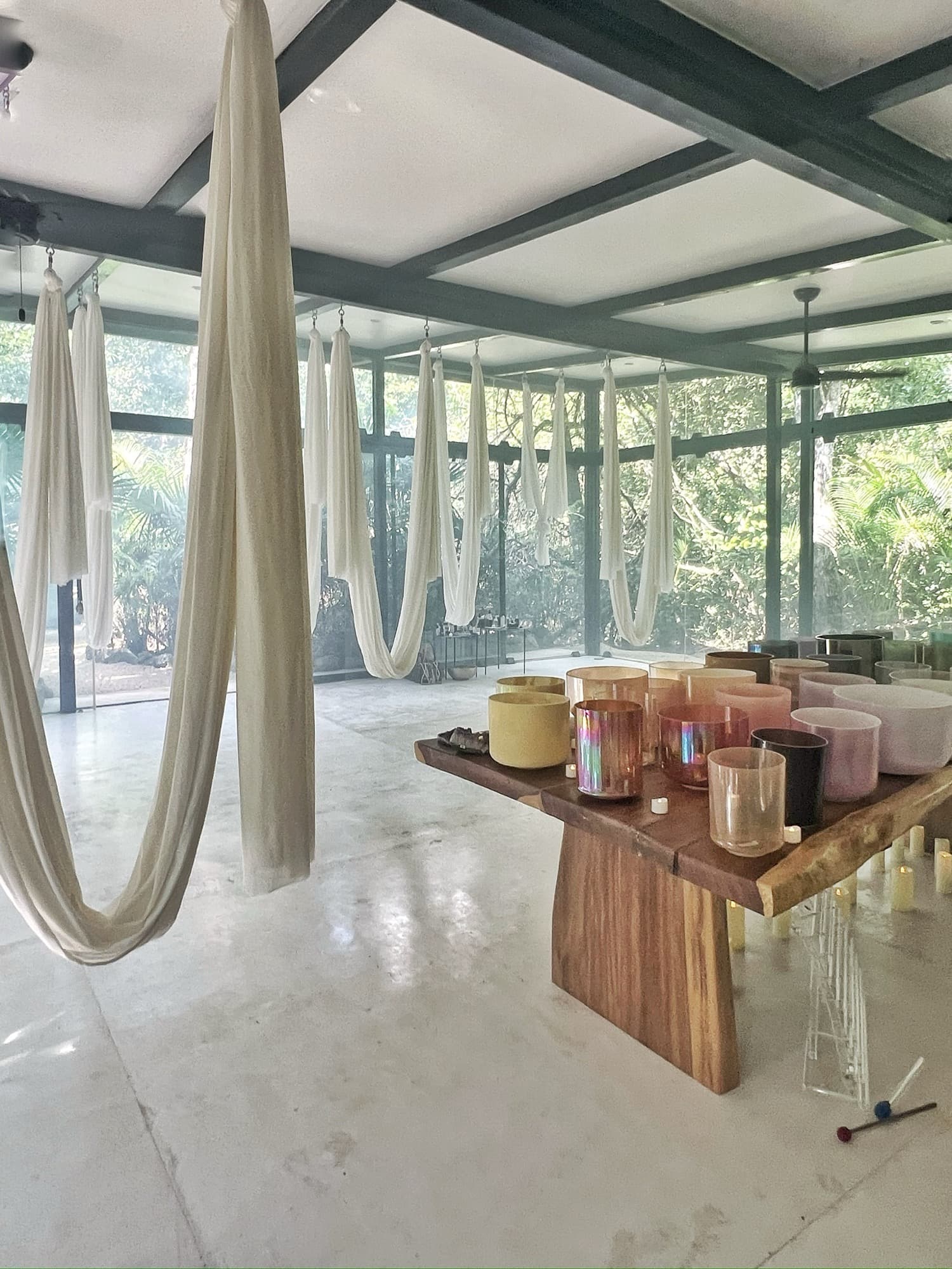 White silks hanging the length of the temple, the altar of bowls on the wooden table