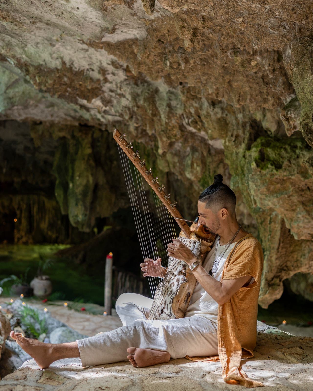 Un facilitador tocando el didgeridoo a la orilla del agua