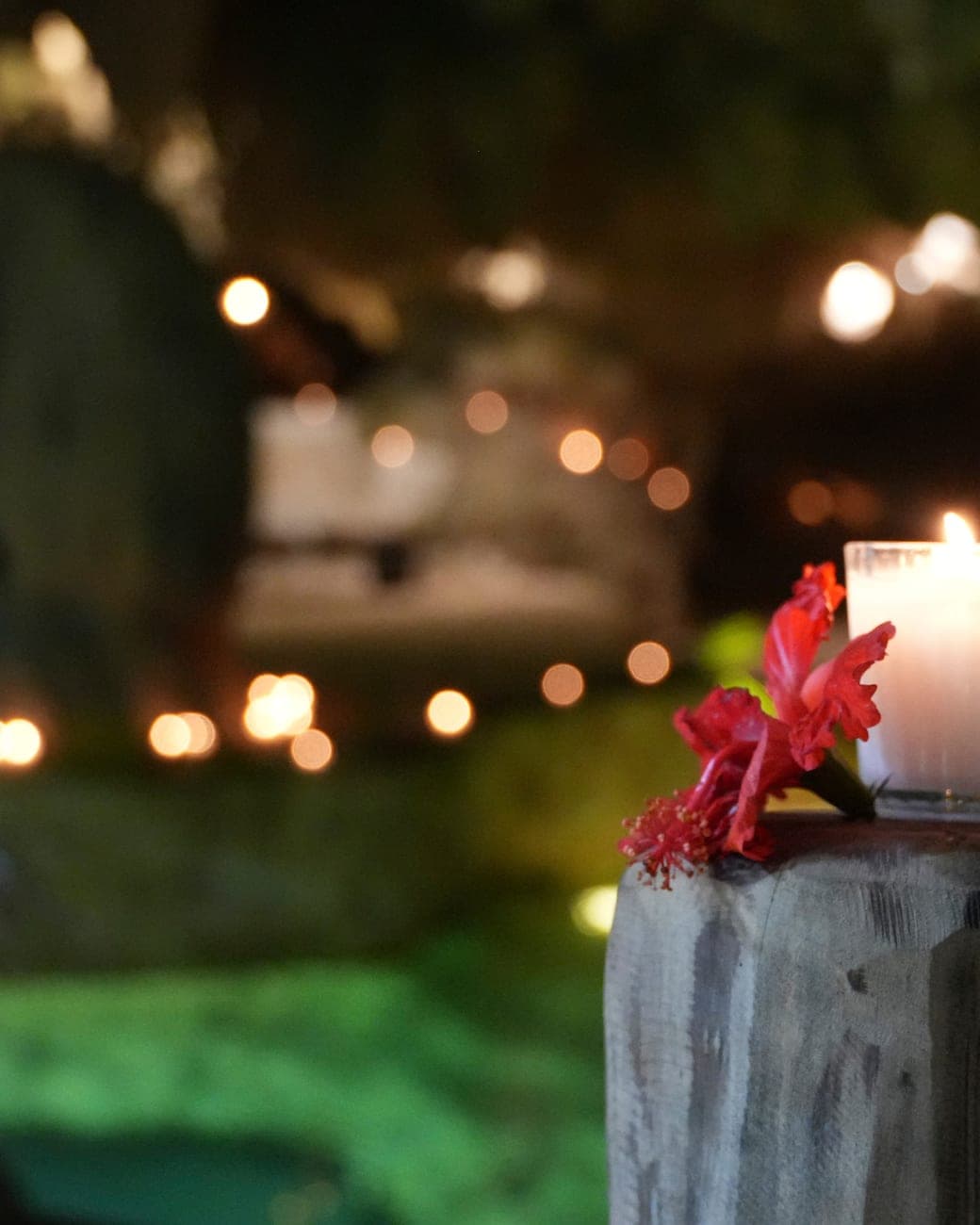 A single candle on stone above the water