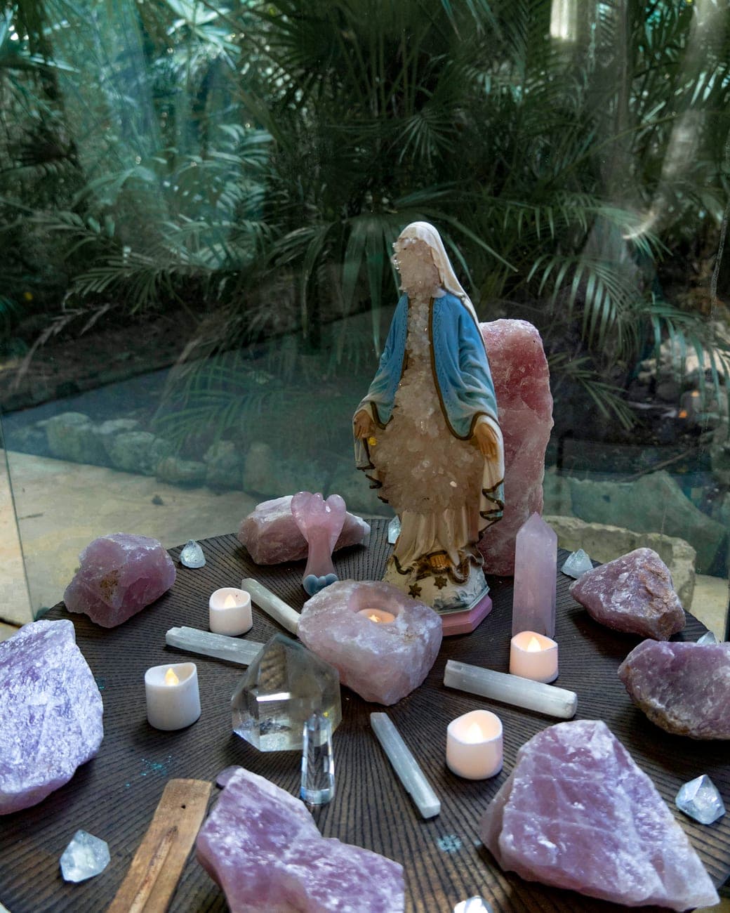 Rose quartz and selenite laid out with candles